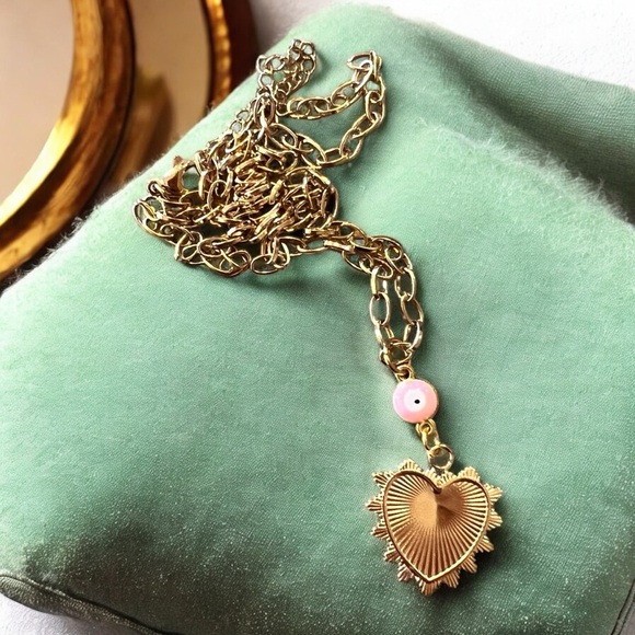 Gold toned chains with black, white, gold, and pastel pink enamel charms. - Picture 12 of 17